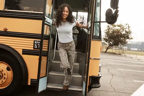 Girl getting off school bus