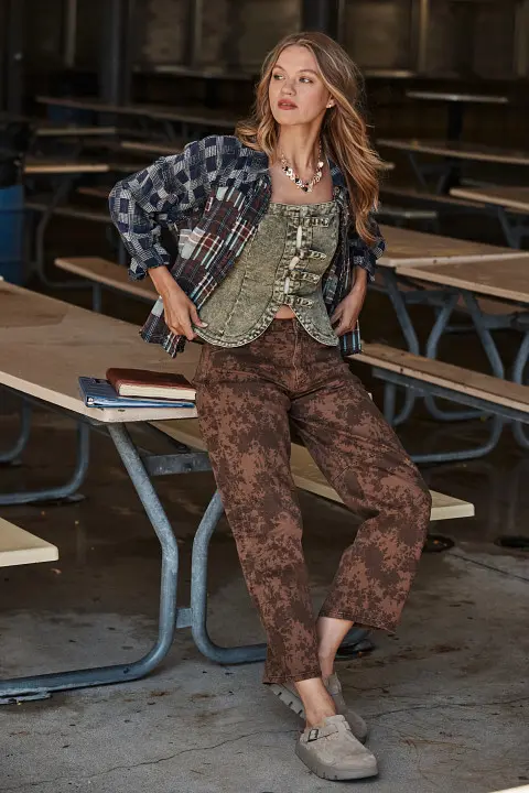 Girl in shirt, vest, and long pants